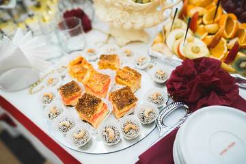 Delicious sweets on wedding candy buffet with desserts, cupcakes