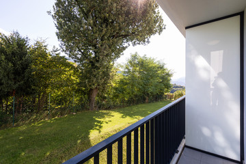 Exterior modern white condominium building with lots of lawn,