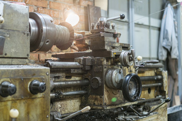 Old machinery in a factory from the mid-20th c. working machine-tool. old lathe.