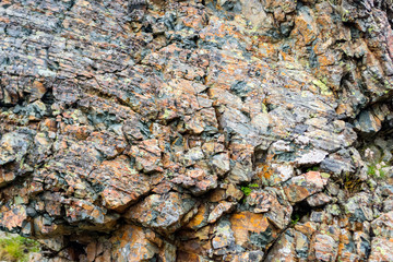 Background texture of a gray brown stone on the rock of the mountain discovered during archaeological excavations as a monument to millions of years of the formation of cancerous deposits under water
