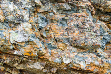 Background texture of a gray brown stone on the rock of the mountain discovered during archaeological excavations as a monument to millions of years of the formation of cancerous deposits under water