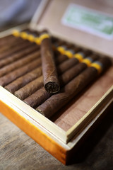 Large box of Cuban cigars on a wooden table