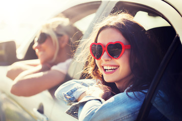 summer holidays, valentines day, travel, road trip and people concept - happy teenage girls or...