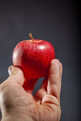 hand holding red apple 