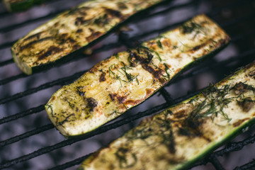 Fresh Green Zucchini Marinated With Garlic And Green Dill Herb, Salt And Back Pepper Cooking On Outdoor BBQ Grill