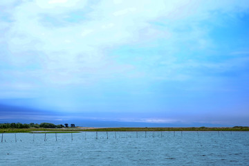 Landscape with turquoise lake and pillars along the lake