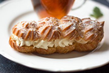 French eclair sweet on the plate on the table