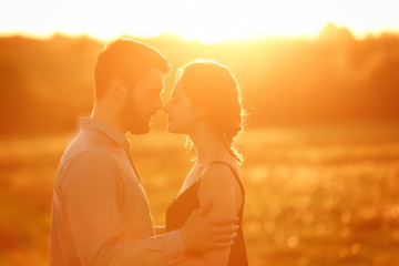 Young couple in love. Portrait of young stylish fashion couple posing in summer in field