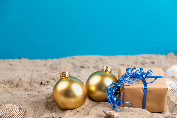 christmas balls and present at a beach