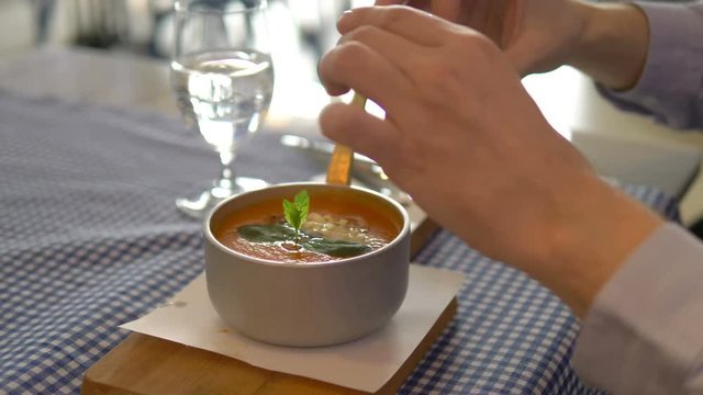 Man taking photos of tomato soup by smartphone in 4k slow motion 60fps