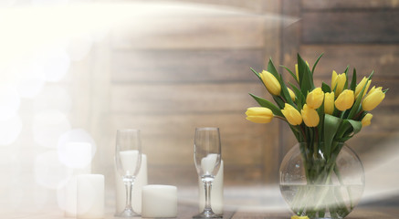  bouquet of yellow tulips in a vase on the floor