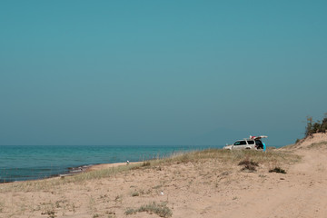 Sandy beach and the road to bright noon