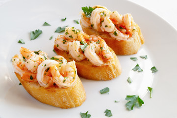 fried bread with fried in garlic oil prawns decorated with parsley