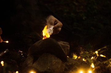 Person lighting a fire for small altar