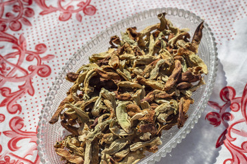 Angled top shoot of dried string beans on tranparent plate