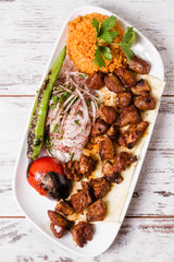 Authentic Turkish Shish Kebab in White Plate on White Wooden Background