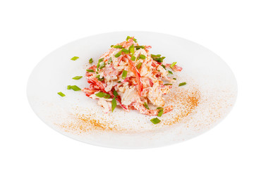 Salad with Bulgarian pepper, meat, chicken, squid, crab sticks, egg, mayonnaise, green onion, spicy on plate, white isolated background Side view. For the menu, restaurant bar cafe
