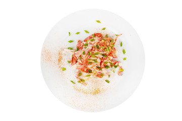 Salad with Bulgarian pepper, meat, chicken, squid, crab sticks, egg, mayonnaise, green onion, spicy on plate, white isolated background, view from above, for the menu restaurant bar cafe
