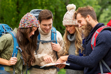 travel, tourism, hiking and people concept - group of happy friends or travelers with backpacks and...