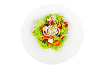 Greek salad with feta, olives, lettuce, red onion, cucumber, cherry tomato, bell pepper, oil on plate, white isolated background, view from above, for the menu, restaurant bar cafe