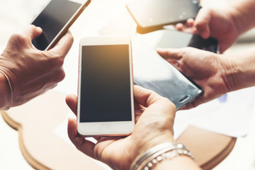 In the meeting time at company.Business team together use hand phone consultation and meeting, connection