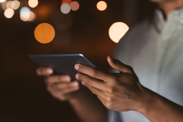 Businessman working with a digital tablet late in the evening