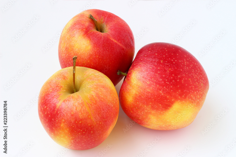 Wall mural three red apples on a white background