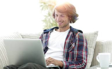 serious guy working on laptop at home