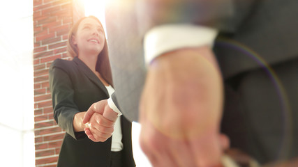 Close up of businessman and businesswoman shaking hands