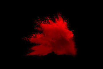 Red powder explosion on black background. Colored cloud. Colorful dust explode. Paint Holi.