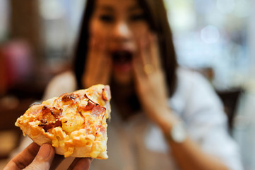 Asian women happy and surprise with pizza in some body's hand,Women happy for her meal is...