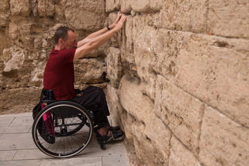 disabled person , wheelchair travel and  wall