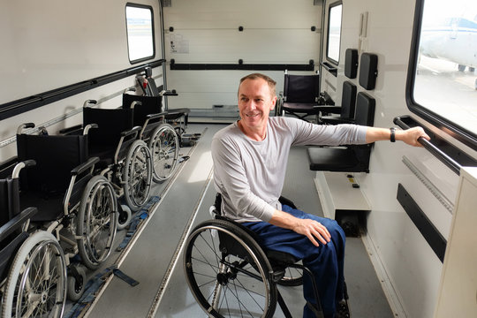 a man in a wheelchair inside a special ambulift at the airport, man on wheelchair airport arrival