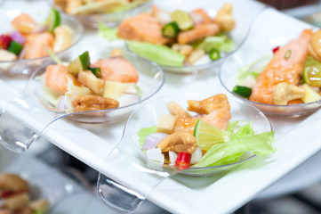 spicy salmon salad snacks on plastic spoons