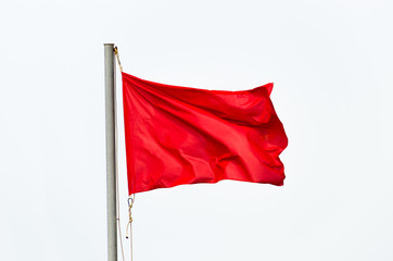 Red flag waving isolated over white