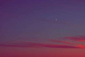 sunset half moon pink clouds.