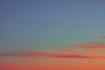 sunset half moon pink clouds.