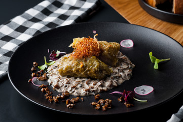 golubtsi Cabbage with rice and meat on a plate of buckwheat and carrots