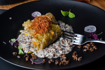 golubtsi Cabbage with rice and meat on a plate of buckwheat and carrots