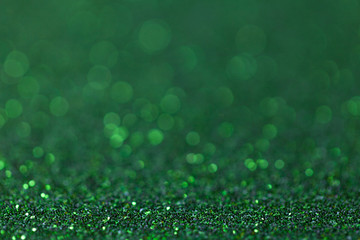 Green sparkling background from small sequins, closeup. Brilliant backdrop