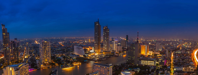 Beautiful aerial view Panorama day to night time lapse of Bangkok commercial district by the Chao Praya River, Thailand