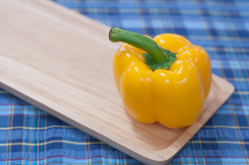 Sweet pepper on wood pan and fabric pattern background