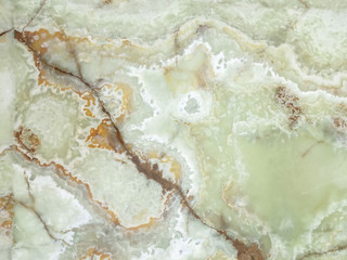 Naklejka na ściany i meble Green marble in a cut close-up with white impregnations.