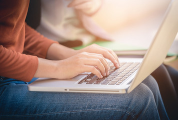 Young woman using laptop computer at outside office.