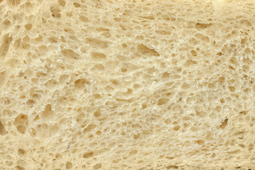Background of a slice of freshly baked white bread close-up.