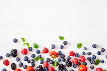 assorted berries over white background. blueberry, strawberry, raspberry, blackberry © Olga Miltsova