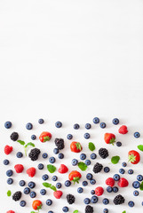 assorted berries over white background. blueberry, strawberry, raspberry, blackberry
