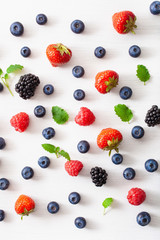 assorted berries over white background. blueberry, strawberry, raspberry, blackberry