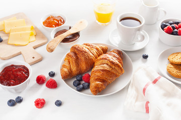 Continental breakfast with croissant, jam, chocolate spread and coffee