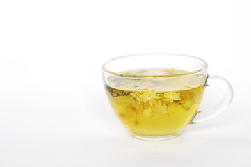 Photo of herbal tea in a transparent cup. flowers and leaves of herbs. flowers of linden and elderberry, leaves of mint. time for relaxation. hot tea. use for background, text, for your design, card
